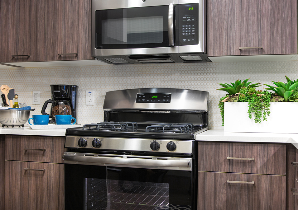 Kitchen with stainless steel appliances and tile backsplash